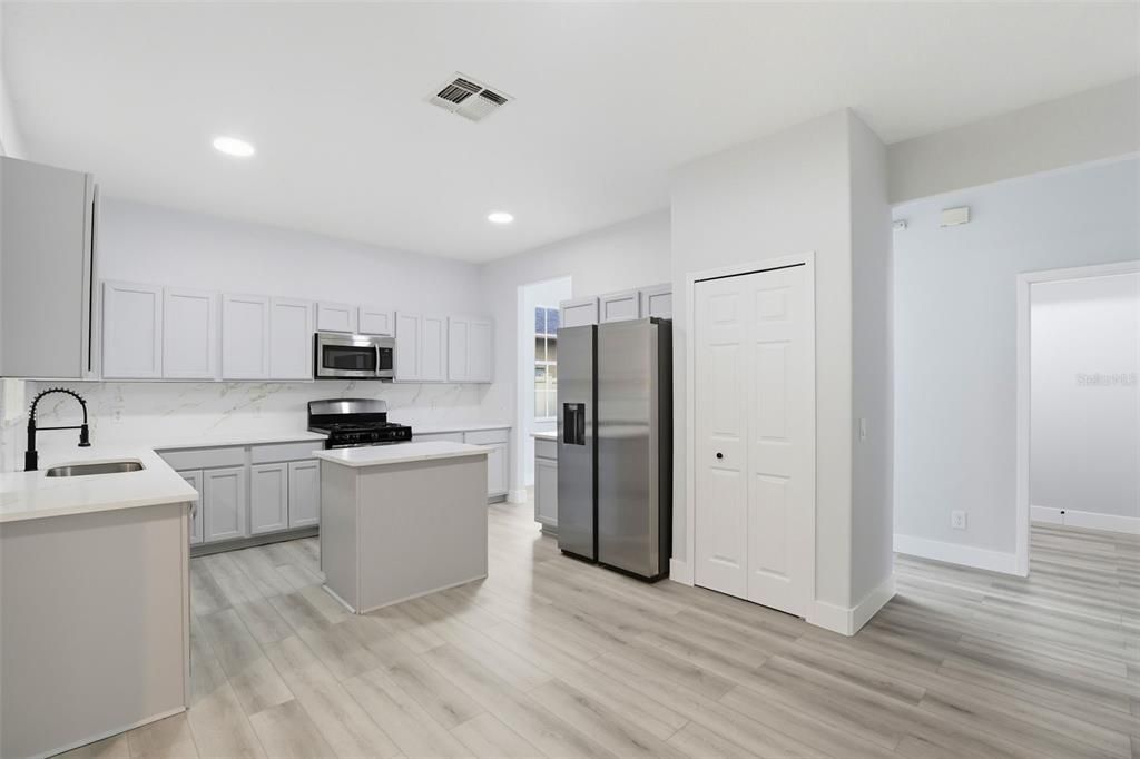 Interior, Kitchen, Marble Walls, Recessed Lighting, Stainless Steel Appliances, Wood Texture Flooring