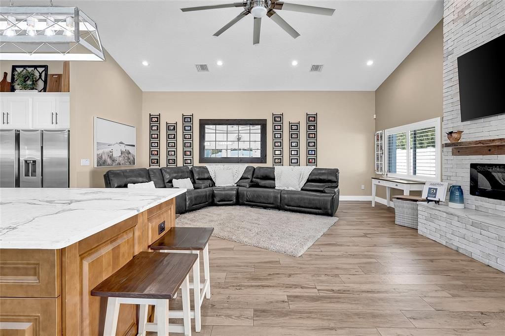 Fireplace, Interior, Kitchen, Living room, Recessed Lighting, Stainless Steel Appliances, Stone Walls, Wood Texture Flooring