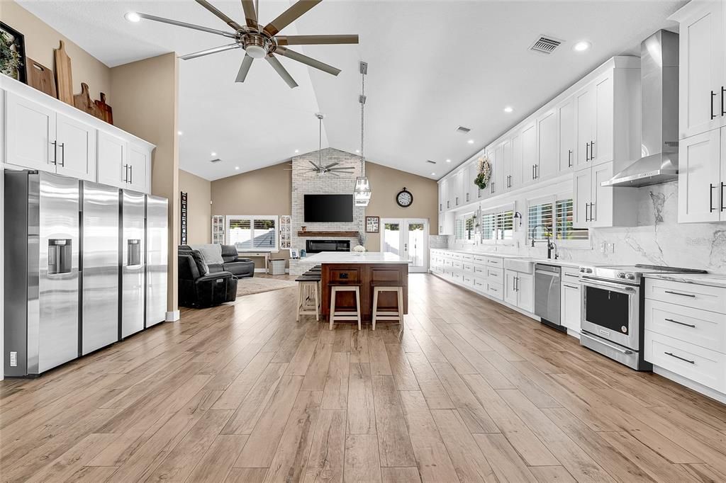 Fireplace, Interior, Kitchen, Living room, Recessed Lighting, Stainless Steel Appliances, Wood Texture Flooring