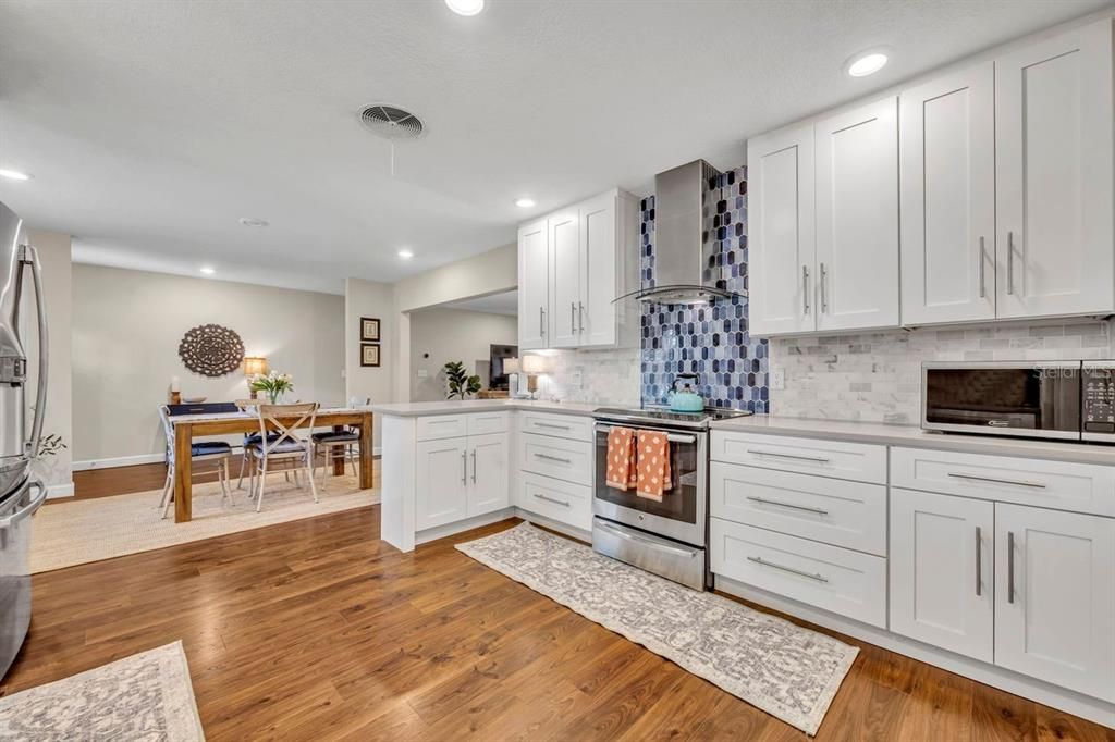 Dining room, Interior, Kitchen, Recessed Lighting, Stainless Steel Appliances, Wood Texture Flooring