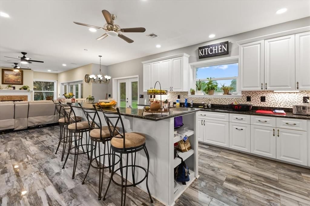 Chandelier, Dining room, Interior, Kitchen, Living room, Recessed Lighting, Wood Texture Flooring