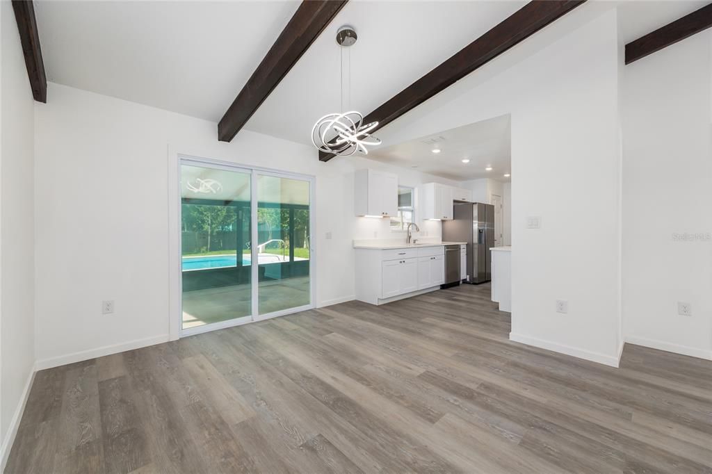 Empty room, Interior, Kitchen, Pendant Lights, Recessed Lighting, Stainless Steel Appliances, Wooden Beams, Wood Texture Flooring