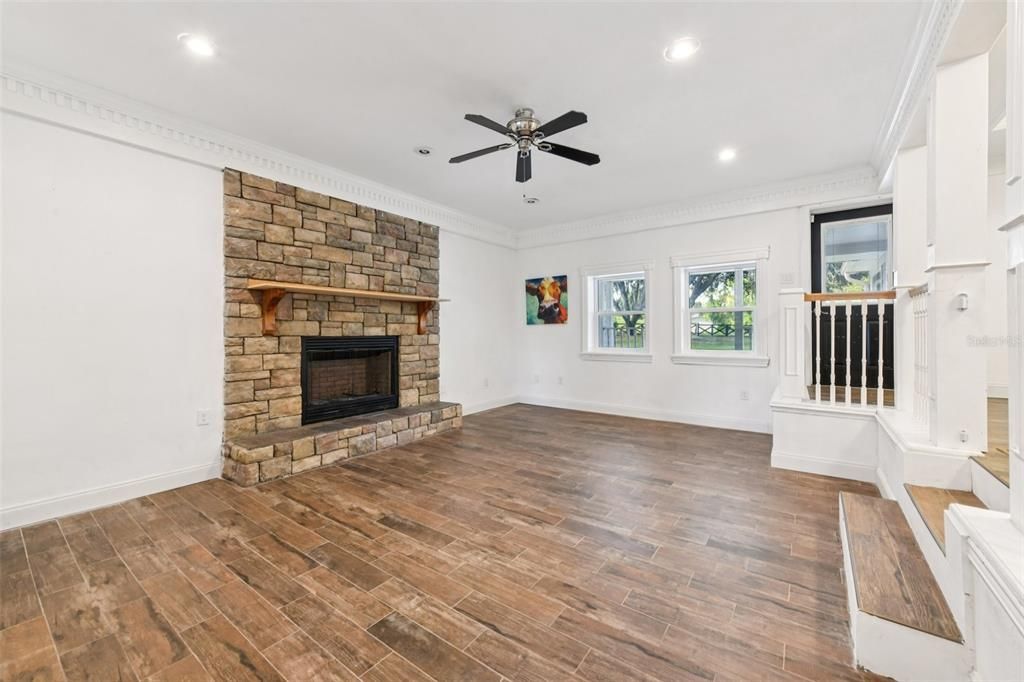 Empty room, Fireplace, Interior, Recessed Lighting, Stone Walls, Wood Texture Flooring