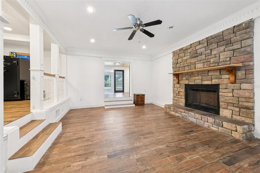 Empty room, Fireplace, Interior, Recessed Lighting, Stone Walls, Wood Texture Flooring
