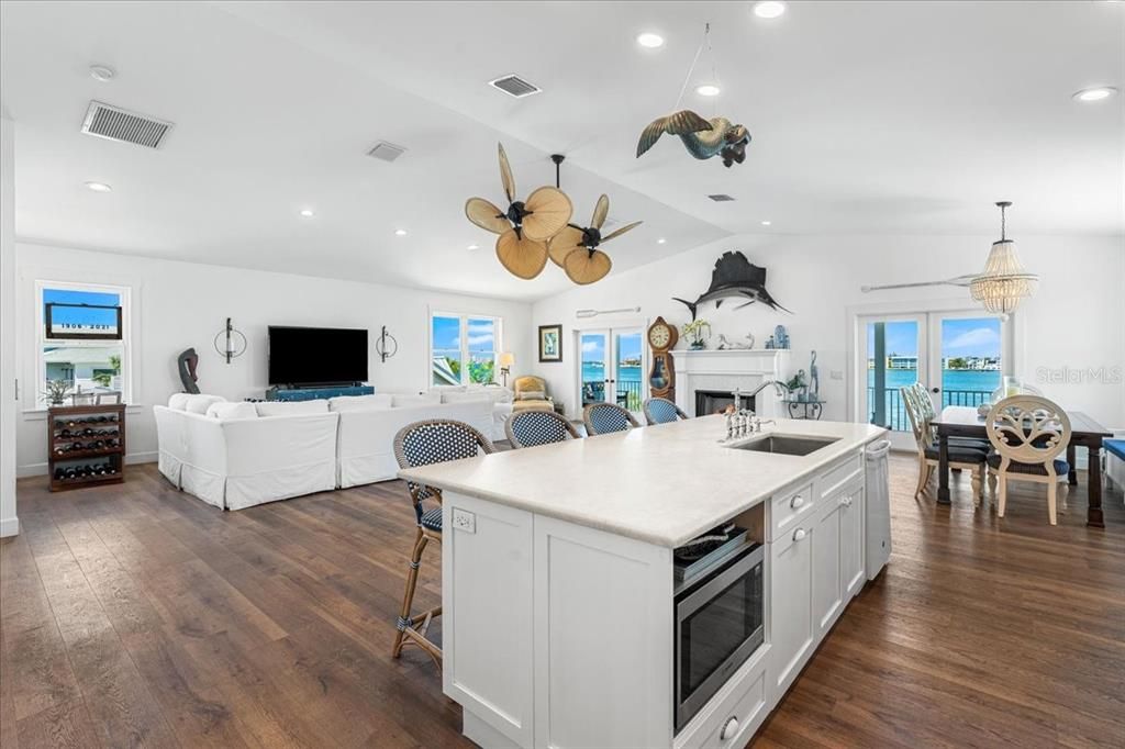 Dining room, Fireplace, Interior, Kitchen, Living room, Pendant Lights, Recessed Lighting, Water, Wood Texture Flooring