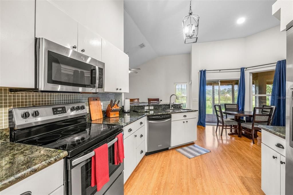 Dining room, Interior, Kitchen, Pendant Lights, Recessed Lighting, Stainless Steel Appliances, Wood Texture Flooring