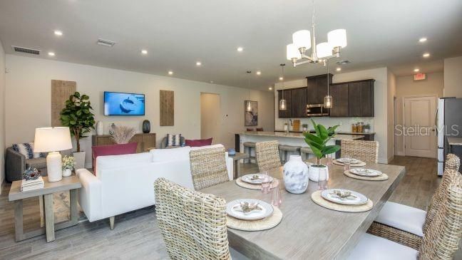 Chandelier, Dining room, Interior, Kitchen, Living room, Pendant Lights, Recessed Lighting, Stainless Steel Appliances, Wood Texture Flooring