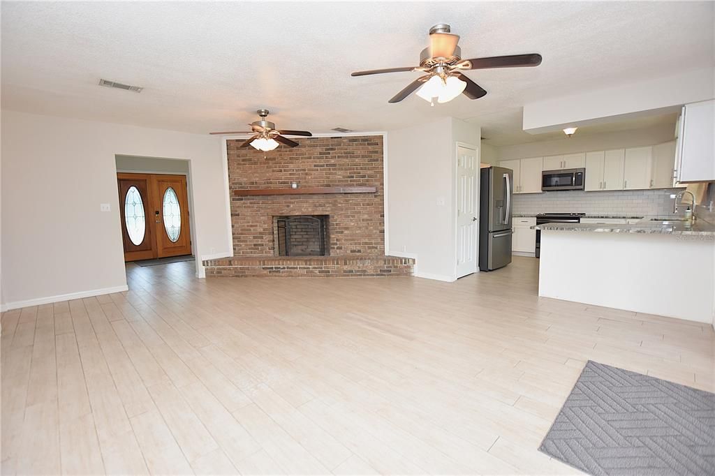 Empty room, Fireplace, Interior, Kitchen, Stainless Steel Appliances, Stone Walls, Wood Texture Flooring