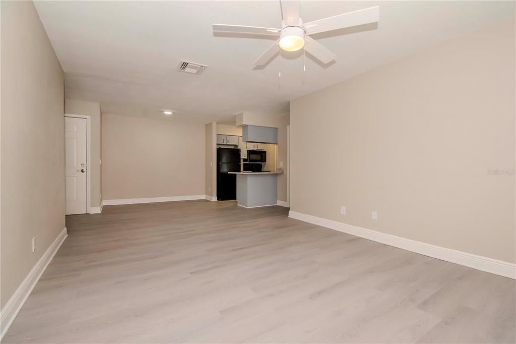 Empty room, Interior, Kitchen, Recessed Lighting, Stainless Steel Appliances, Wood Texture Flooring