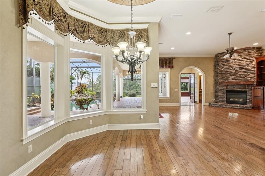 Chandelier, Empty room, Fireplace, Interior, Recessed Lighting, Stone Walls, Wood Texture Flooring
