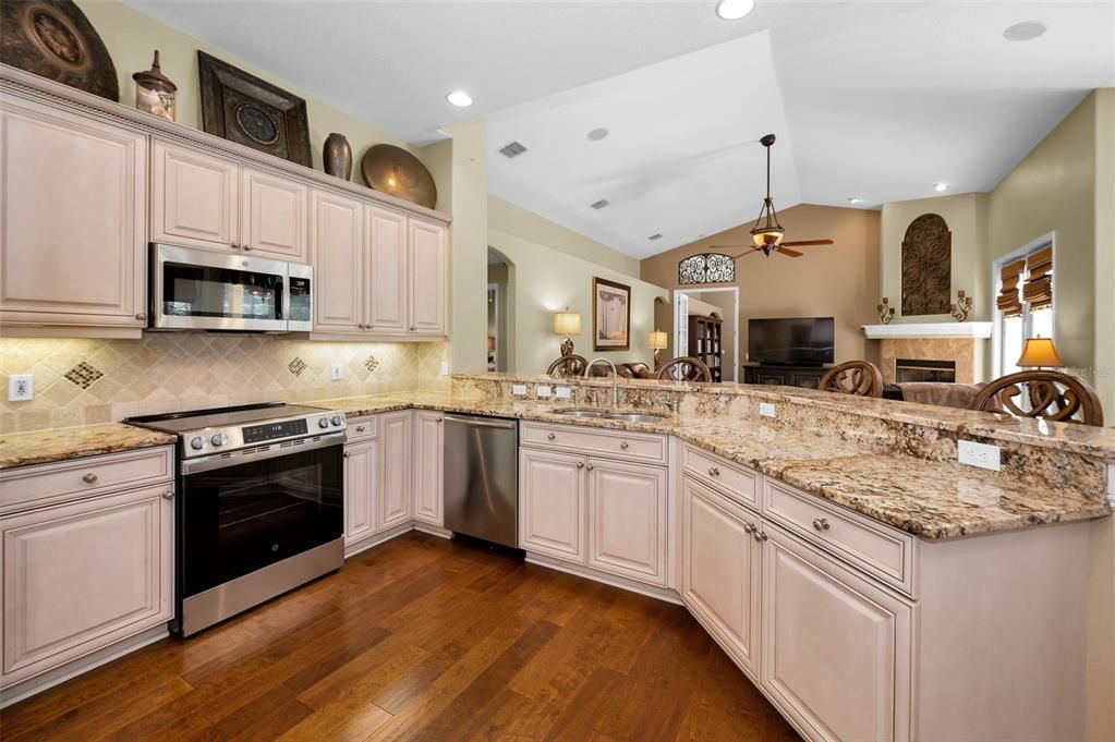 Fireplace, Interior, Kitchen, Recessed Lighting, Stainless Steel Appliances, Wood Texture Flooring