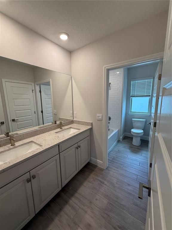 Bathroom, Dual Sink Vanities, Interior, Recessed Lighting, Wood Texture Flooring