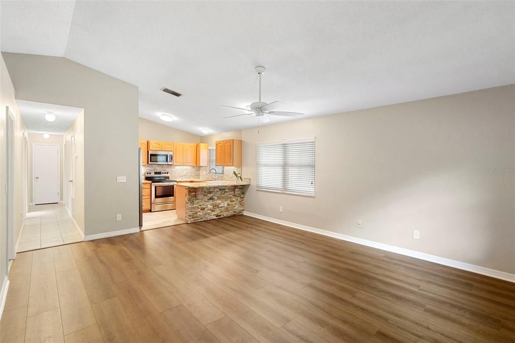 Empty room, Interior, Kitchen, Recessed Lighting, Stainless Steel Appliances, Wood Texture Flooring