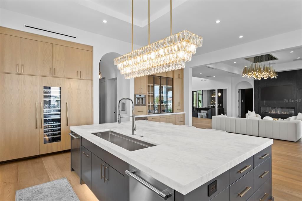 Chandelier, Fireplace, Interior, Kitchen, Living room, Recessed Lighting, Stainless Steel Appliances, Wood Texture Flooring