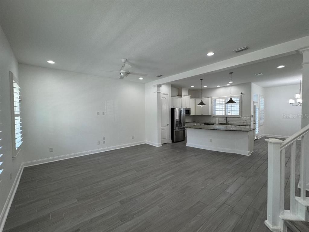 Empty room, Interior, Kitchen, Pendant Lights, Recessed Lighting, Stainless Steel Appliances, Wood Texture Flooring