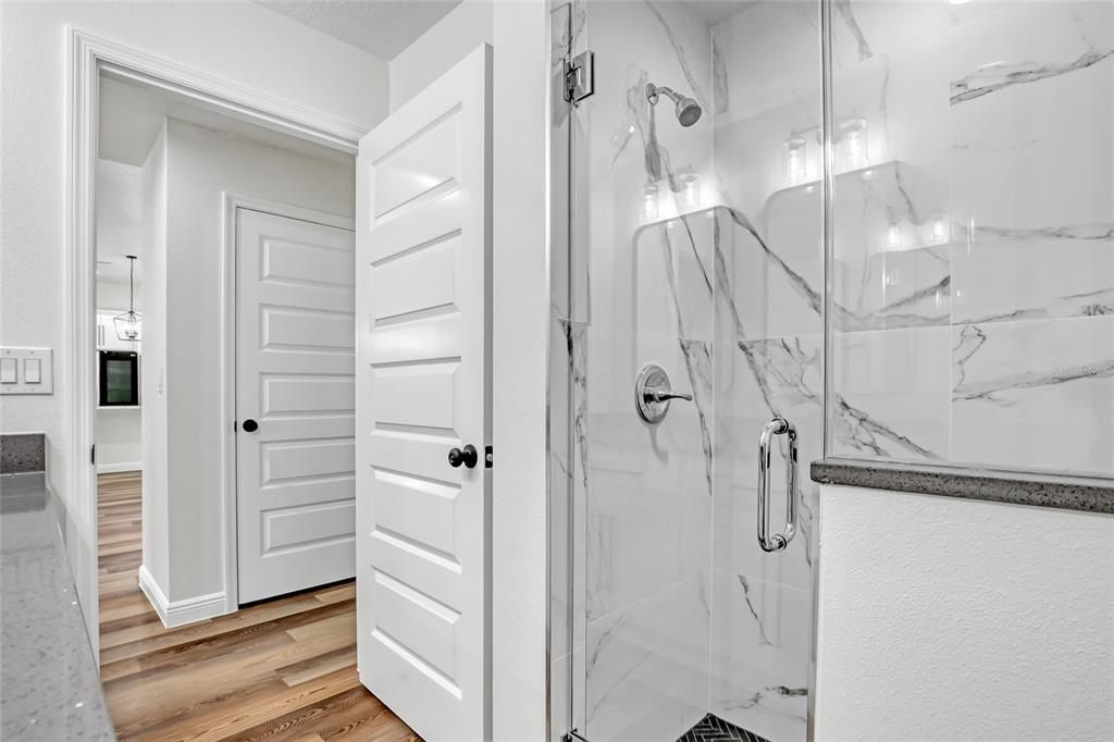 Bathroom, Glass Shower, Interior, Marble Walls, Wood Texture Flooring