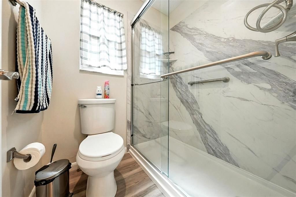 Bathroom, Glass Shower, Interior, Marble Walls, Wood Texture Flooring