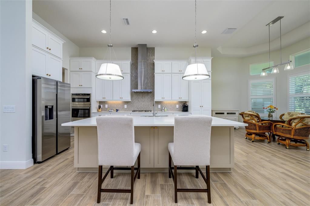 Dining room, Interior, Kitchen, Pendant Lights, Recessed Lighting, Stainless Steel Appliances, Wood Texture Flooring