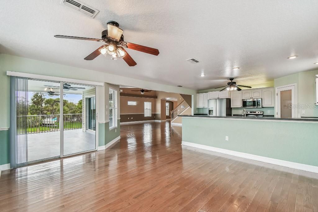 Empty room, Interior, Kitchen, Recessed Lighting, Stainless Steel Appliances, Wood Texture Flooring