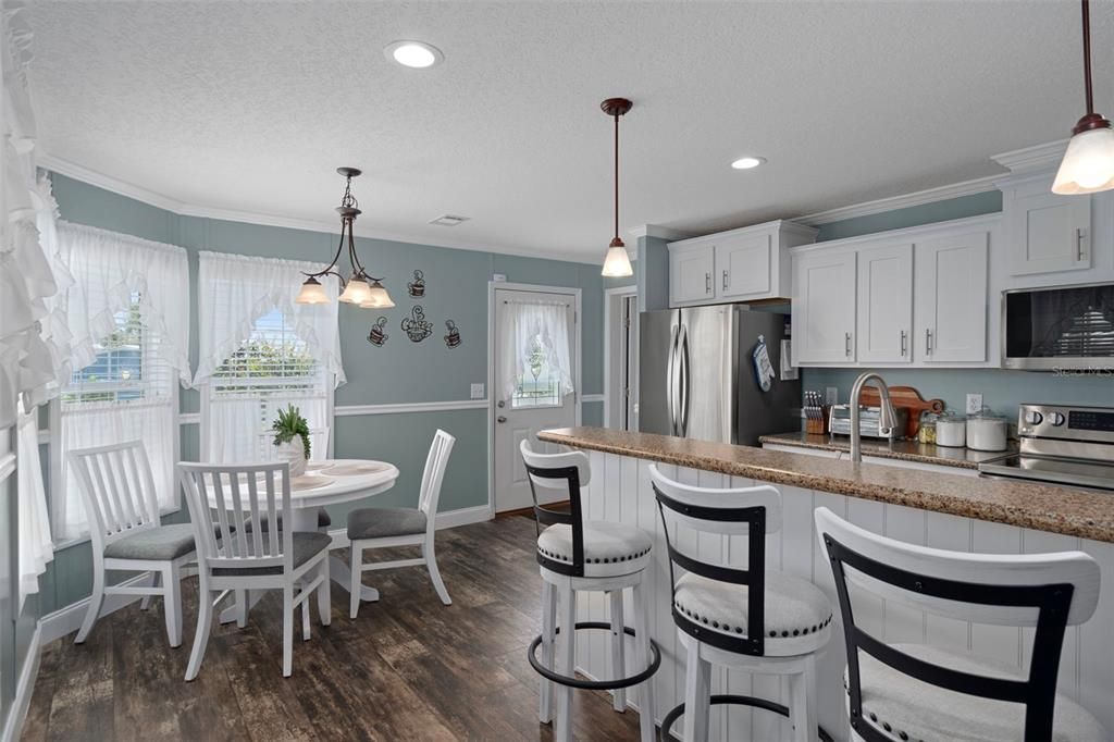 Dining room, Interior, Kitchen, Pendant Lights, Recessed Lighting, Stainless Steel Appliances, Wood Texture Flooring