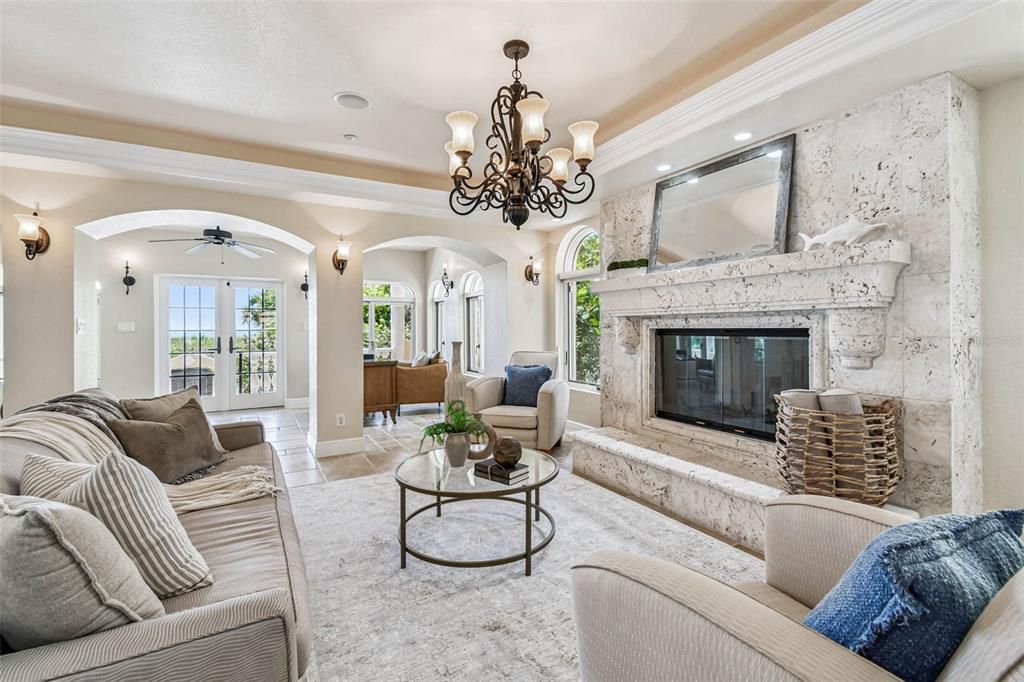 Chandelier, Fireplace, Interior, Living room, Recessed Lighting, Stone Walls, Wood Texture Flooring
