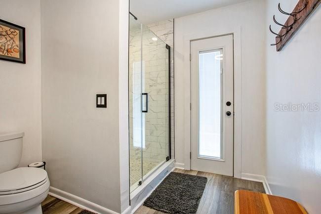 Bathroom, Glass Shower, Interior, Marble Walls, Wood Texture Flooring