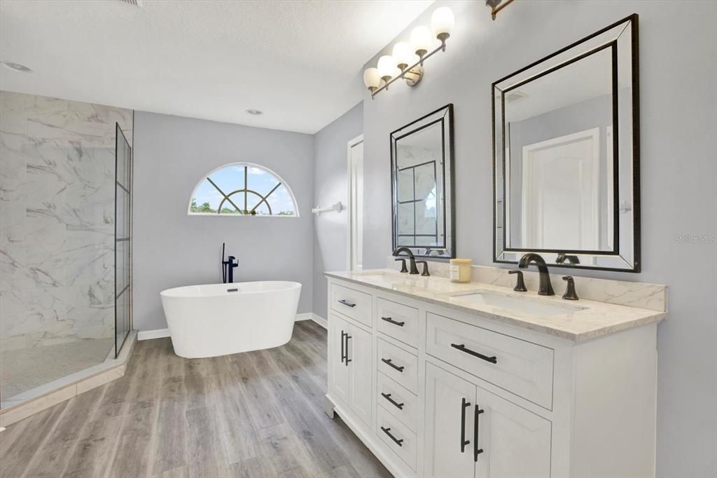 Bathroom, Dual Sink Vanities, Free Standing Baths, Glass Shower, Interior, Marble Walls, Recessed Lighting, Wood Texture Flooring