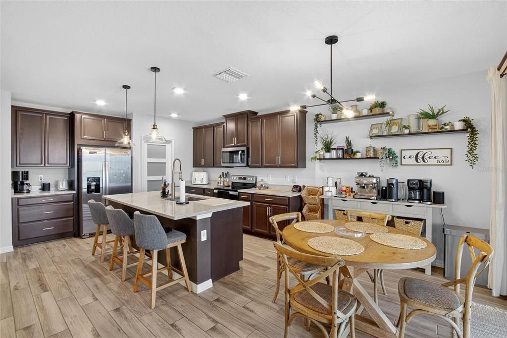 Dining room, Interior, Kitchen, Pendant Lights, Recessed Lighting, Stainless Steel Appliances, Wood Texture Flooring