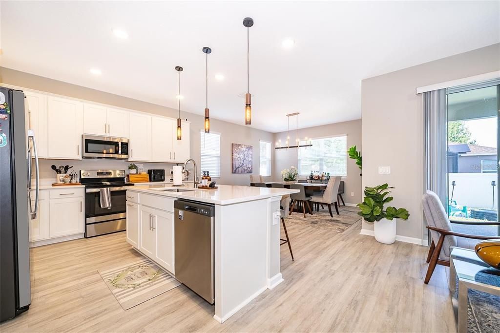 Dining room, Interior, Kitchen, Pendant Lights, Recessed Lighting, Stainless Steel Appliances, Wood Texture Flooring