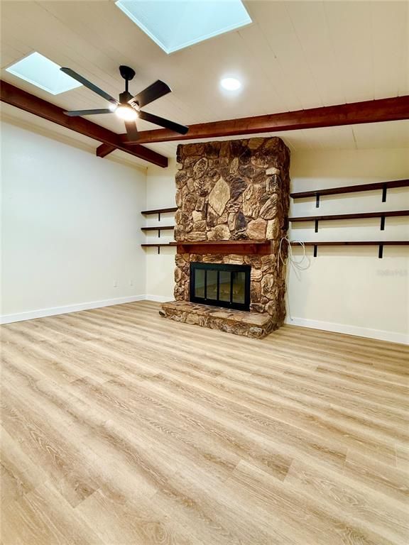 Empty room, Fireplace, Interior, Recessed Lighting, Stone Walls, Wood Texture Flooring