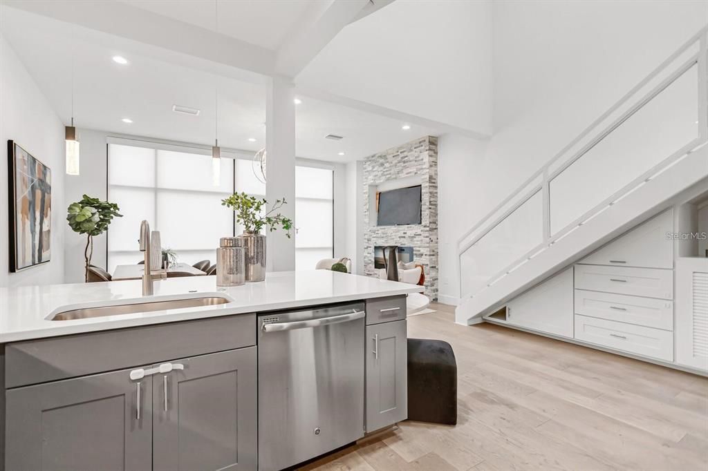 Dining room, Fireplace, Interior, Kitchen, Pendant Lights, Recessed Lighting, Stainless Steel Appliances, Stone Walls, Wood Texture Flooring