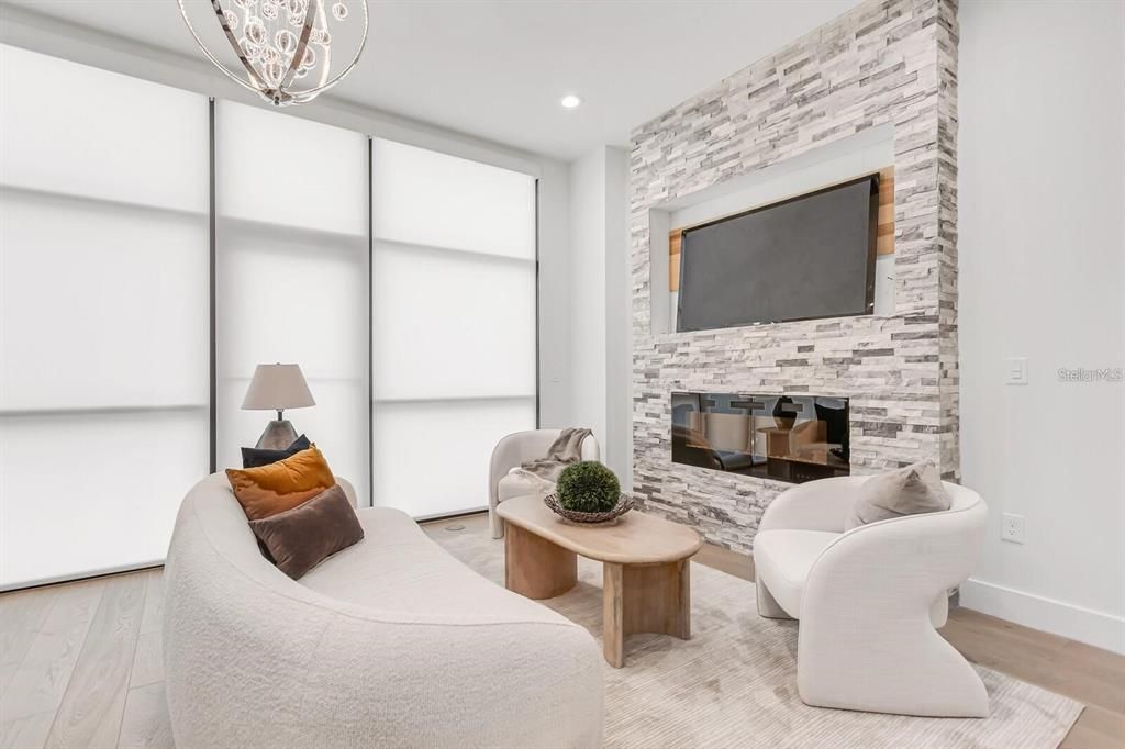 Fireplace, Interior, Living room, Recessed Lighting, Stone Walls, Wood Texture Flooring