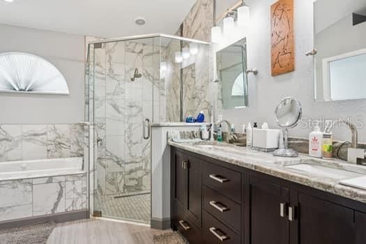 Bathroom, Dual Sink Vanities, Glass Shower, Interior, Marble Walls, Recessed Lighting, Wood Texture Flooring