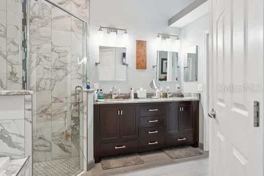 Bathroom, Dual Sink Vanities, Glass Shower, Interior, Marble Walls, Wood Texture Flooring