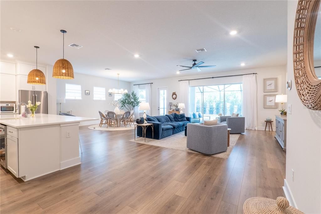Chandelier, Dining room, Interior, Kitchen, Living room, Pendant Lights, Recessed Lighting, Stainless Steel Appliances, Wood Texture Flooring