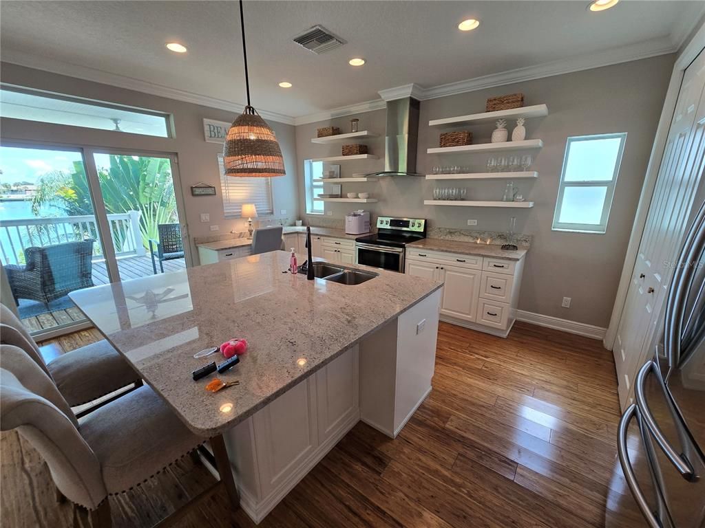 Dining room, Interior, Kitchen, Pendant Lights, Recessed Lighting, Stainless Steel Appliances, Water, Wood Texture Flooring