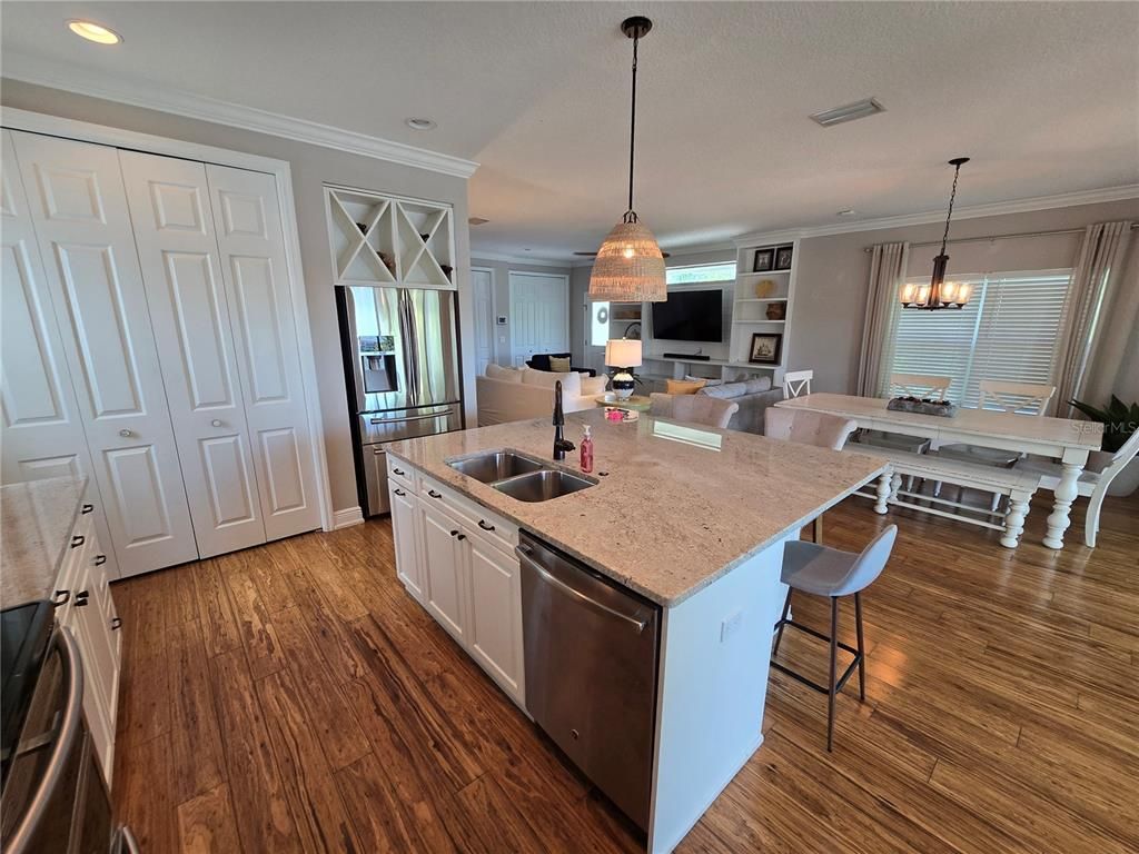 Chandelier, Dining room, Interior, Kitchen, Pendant Lights, Recessed Lighting, Stainless Steel Appliances, Wood Texture Flooring