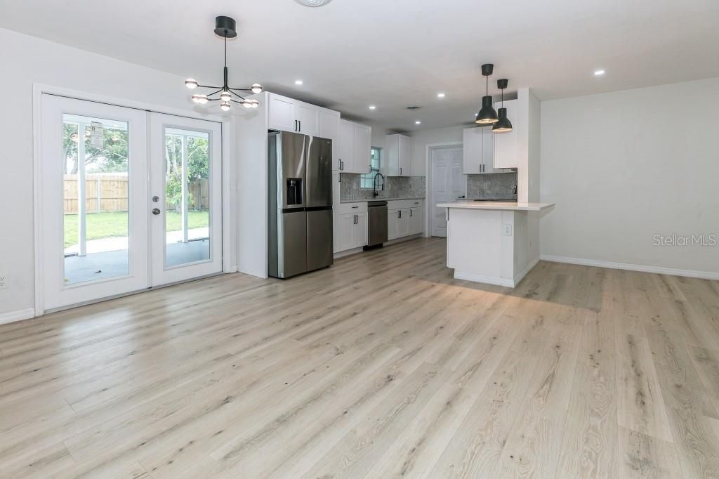 Empty room, Interior, Kitchen, Pendant Lights, Recessed Lighting, Stainless Steel Appliances, Wood Texture Flooring