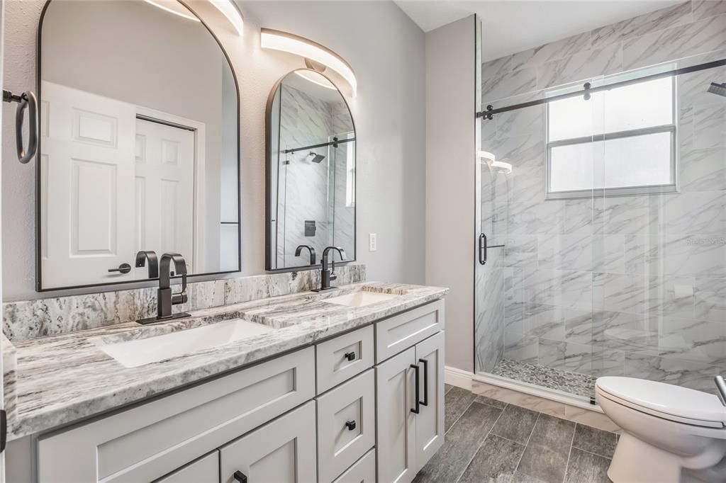 Bathroom, Dual Sink Vanities, Glass Shower, Interior, Marble Walls, Wood Texture Flooring