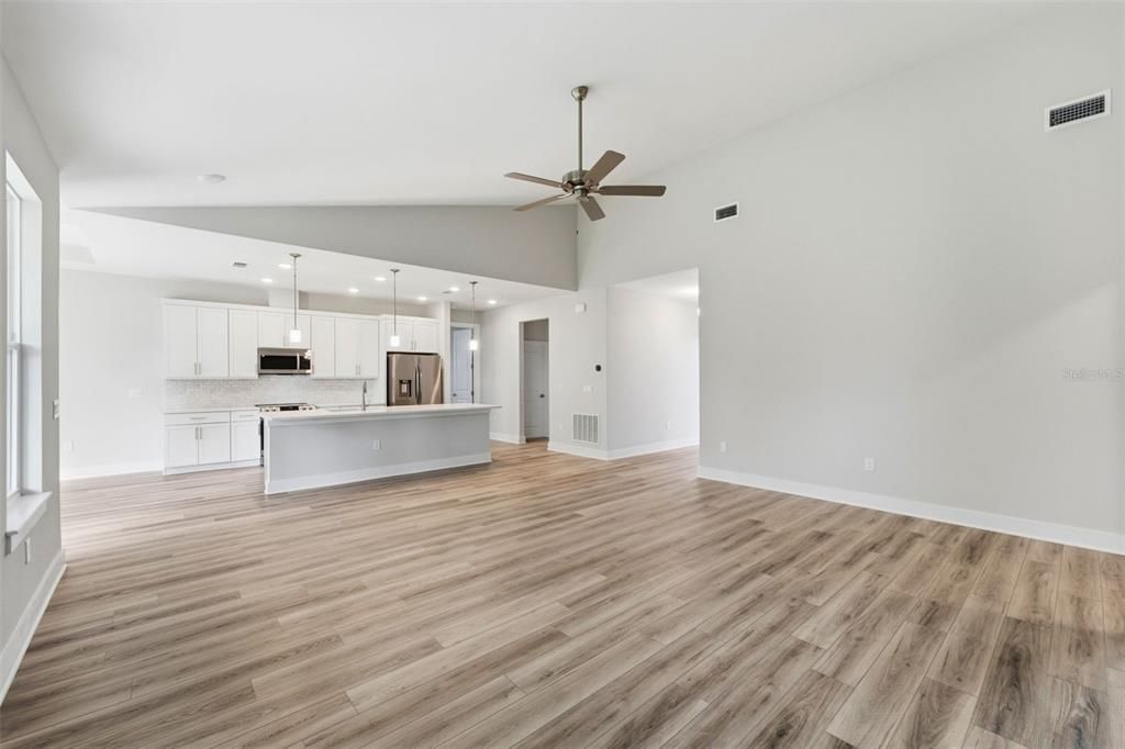 Empty room, Interior, Kitchen, Pendant Lights, Recessed Lighting, Stainless Steel Appliances, Wood Texture Flooring