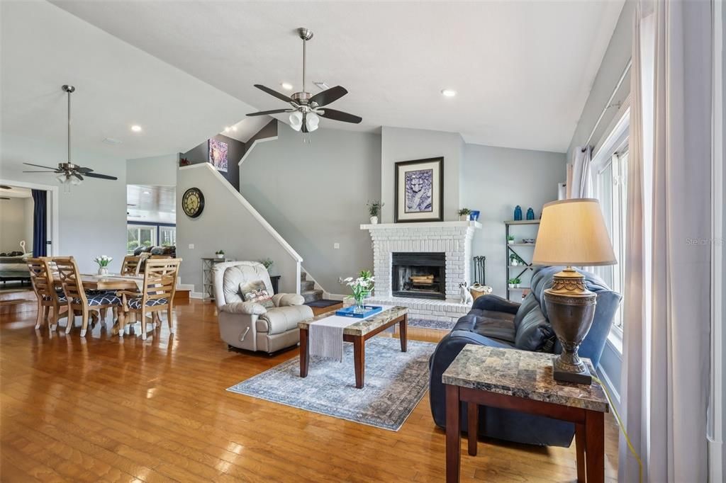 Dining room, Fireplace, Interior, Living room, Recessed Lighting, Wood Texture Flooring