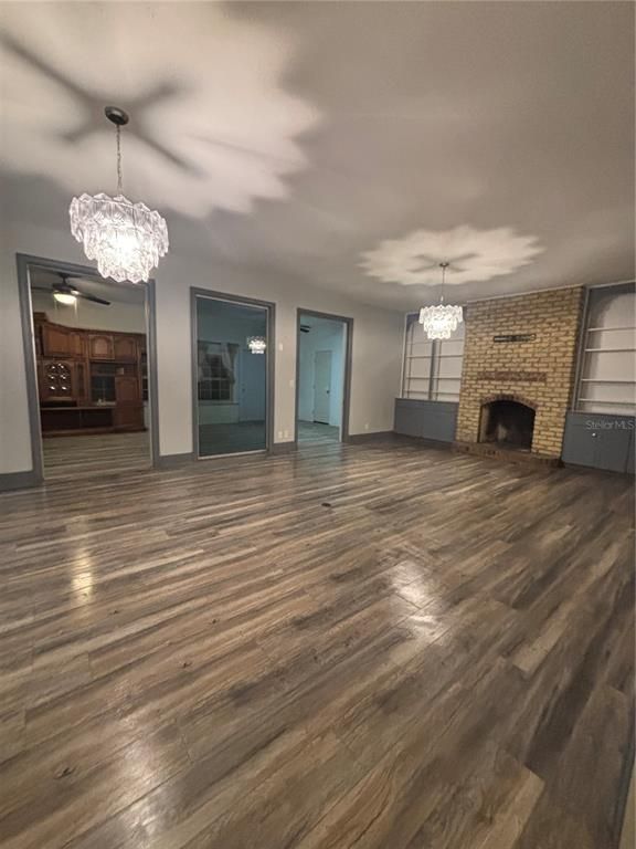 Chandelier, Empty room, Fireplace, Interior, Stone Walls, Wood Texture Flooring