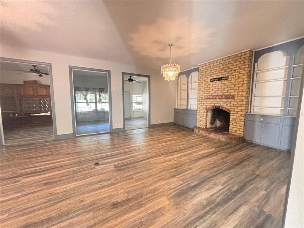 Chandelier, Empty room, Fireplace, Interior, Stone Walls, Wood Texture Flooring