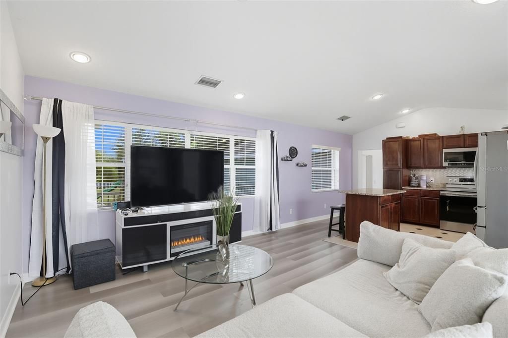 Fireplace, Interior, Kitchen, Living room, Recessed Lighting, Stainless Steel Appliances, Wood Texture Flooring