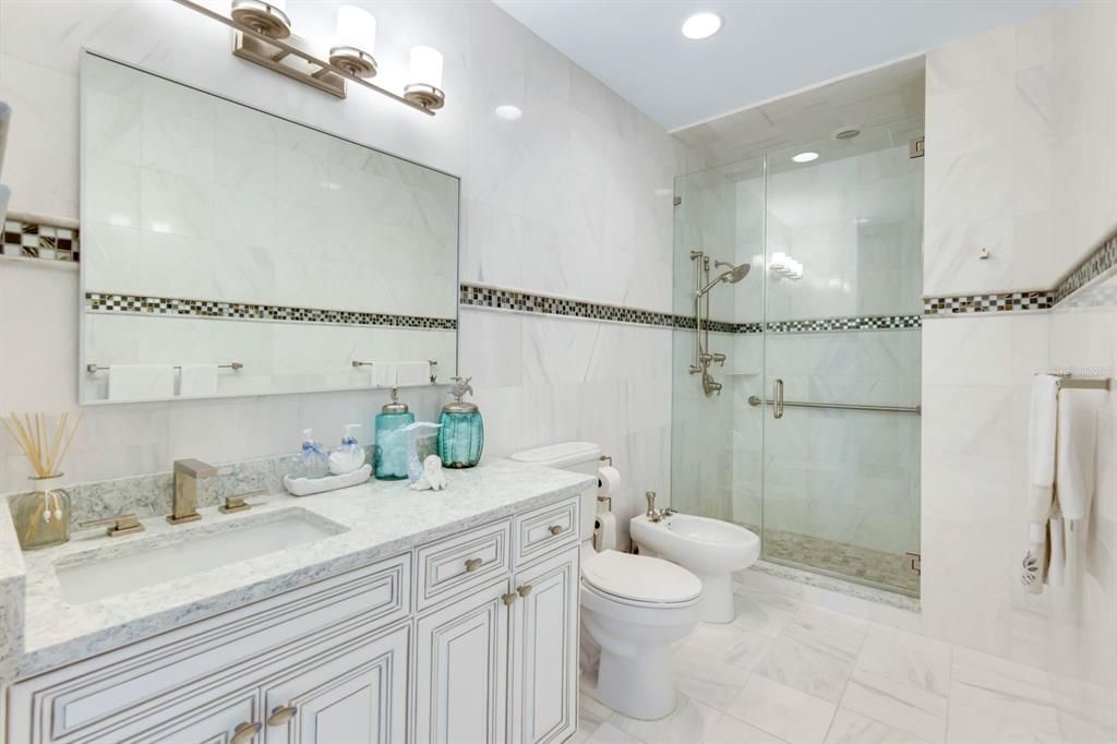 Bathroom, Dual Sink Vanities, Glass Shower, Interior, Marble, Marble Walls, Recessed Lighting