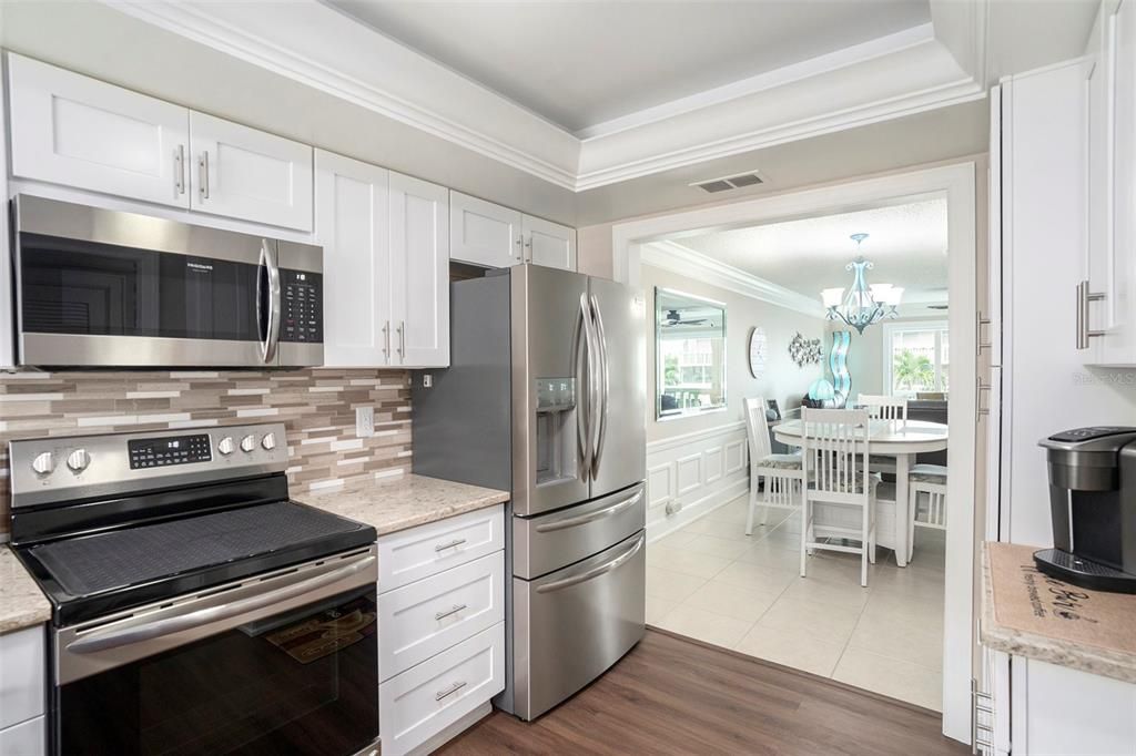Chandelier, Dining room, Interior, Kitchen, Stainless Steel Appliances, Wood Texture Flooring