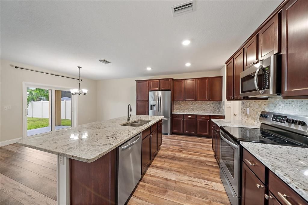 Chandelier, Interior, Kitchen, Recessed Lighting, Stainless Steel Appliances, Wood Texture Flooring