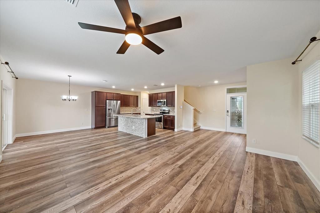 Chandelier, Empty room, Interior, Kitchen, Pendant Lights, Recessed Lighting, Stainless Steel Appliances, Wood Texture Flooring
