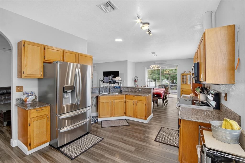 Dining room, Interior, Kitchen, Recessed Lighting, Stainless Steel Appliances, Wood Texture Flooring
