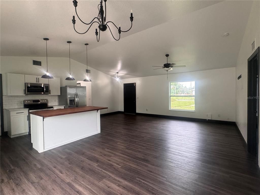 Chandelier, Empty room, Interior, Kitchen, Pendant Lights, Stainless Steel Appliances, Wood Texture Flooring